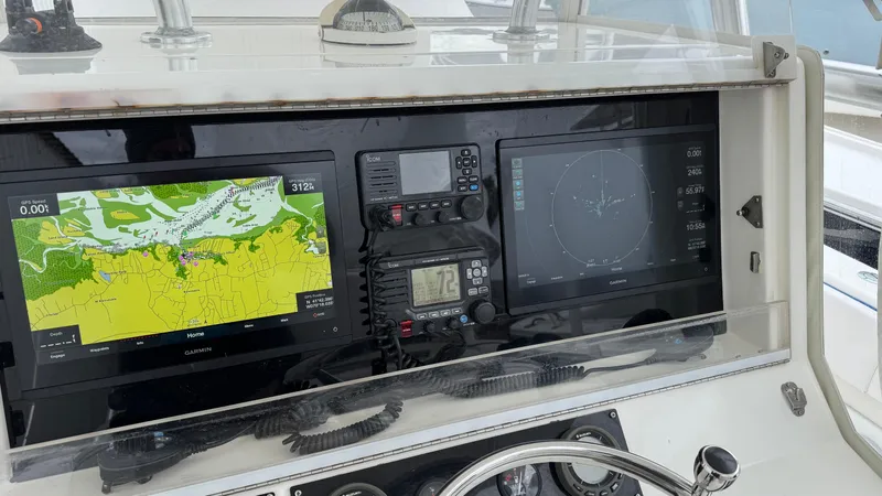 Slide: The Image of Control panel of a 2003 SeaVee 34B boat with navigation and communication equipment. - 4