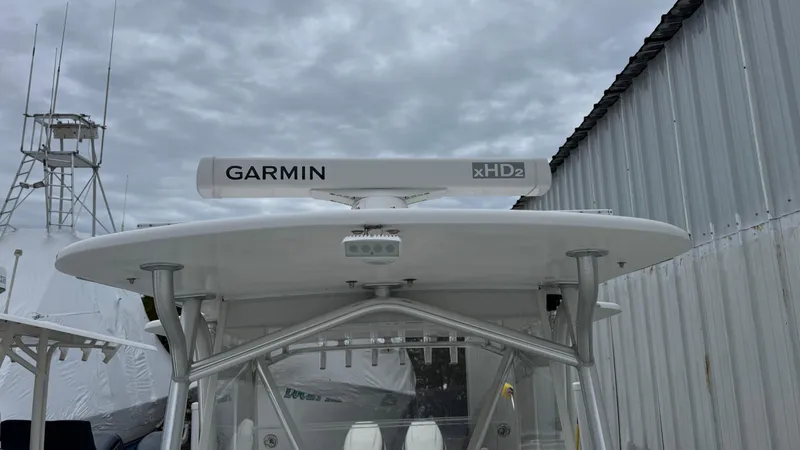 Slide: The Image of 2003 SeaVee 34B boat with Garmin xHD2 radar, docked near a metal building. - 5