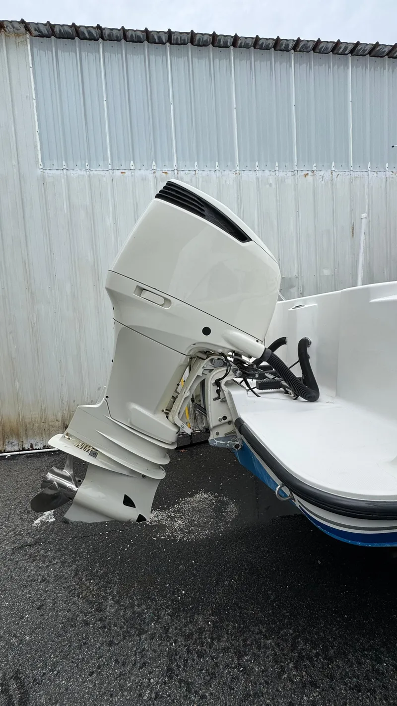 Slide: The Image of 2003 SeaVee 34B boat with outboard motor, parked on wet pavement. - 8