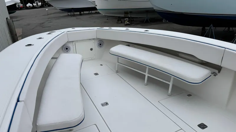 Slide: The Image of 2003 SeaVee 34B boat interior with white cushioned seating and spacious deck. - 9