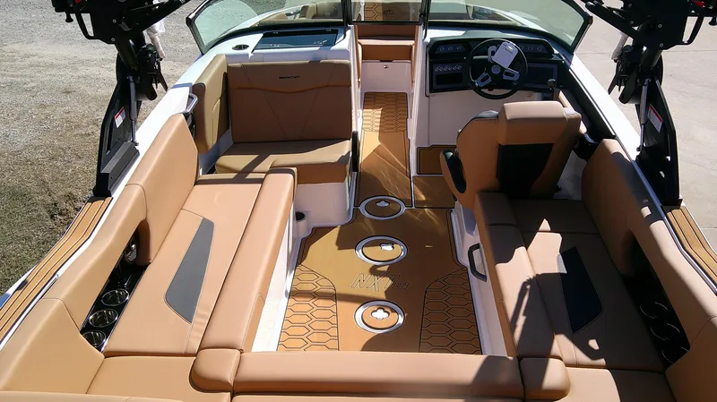 Slide: The Image of 2025 MasterCraft NXT22 boat interior with tan seating and modern dashboard. - 6