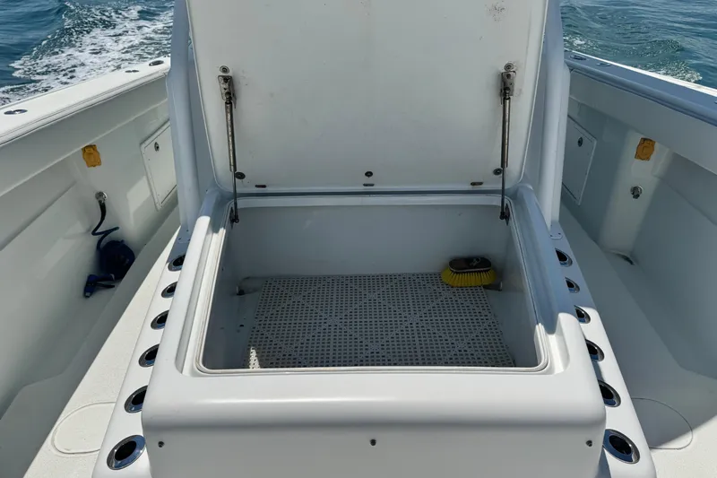Slide: The Image of Open storage compartment on a 2014 Yellowfin 42 Offshore boat, with ocean in the background. - 11