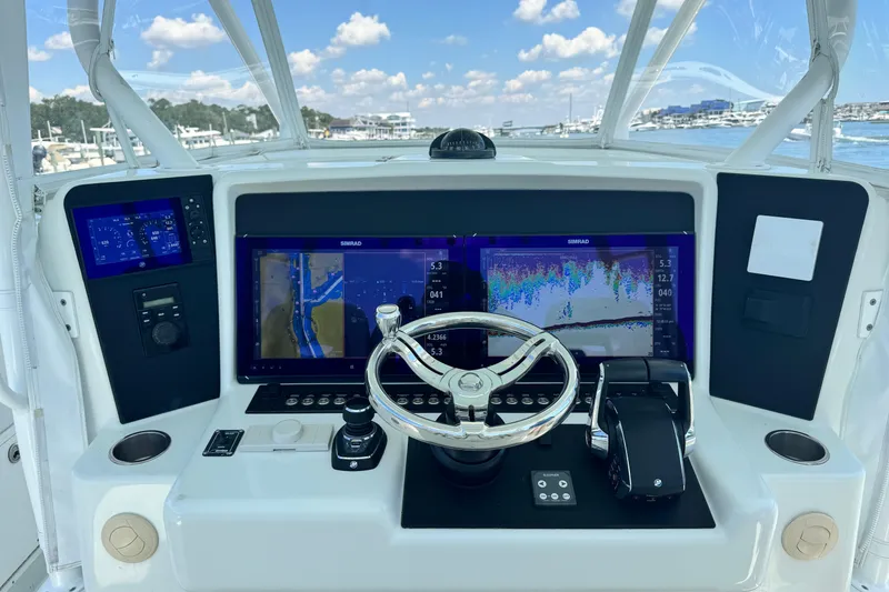 Slide: The Image of 2014 Yellowfin 42 Offshore helm with advanced navigation displays and controls. - 15