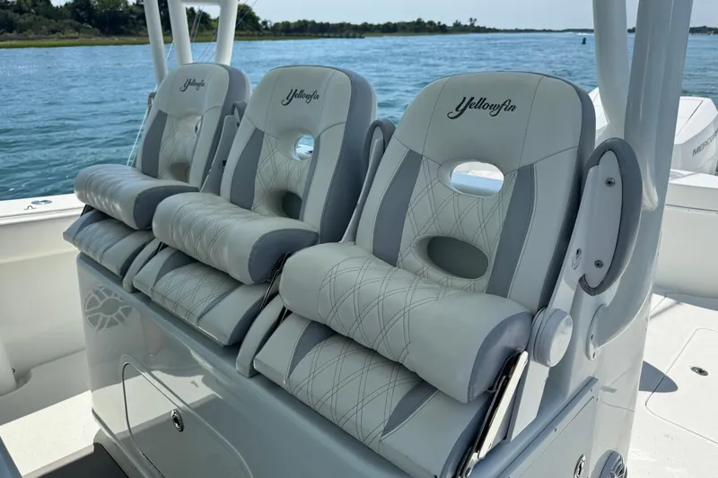 Slide: The Image of Luxury seating on 2014 Yellowfin 42 Offshore boat, featuring plush, embroidered cushions. - 16