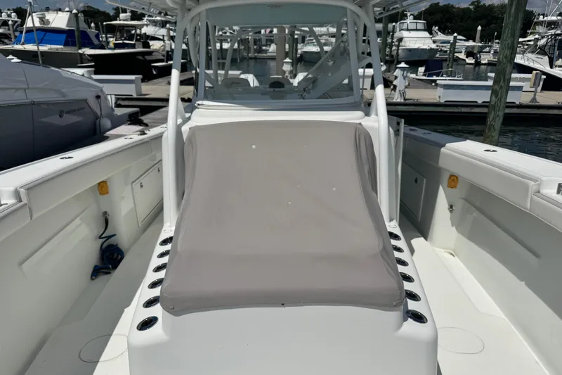 Slide: The Image of 2014 Yellowfin 42 Offshore boat at marina, featuring spacious deck and seating area. - 17