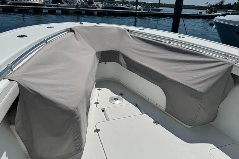 Slide: The Image of 2014 Yellowfin 42 Offshore boat with covered seating area at a marina. - 18