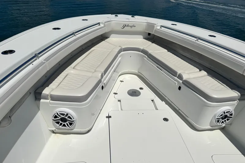 Slide: The Image of 2014 Yellowfin 42 Offshore boat with spacious seating and sleek design on calm water. - 19