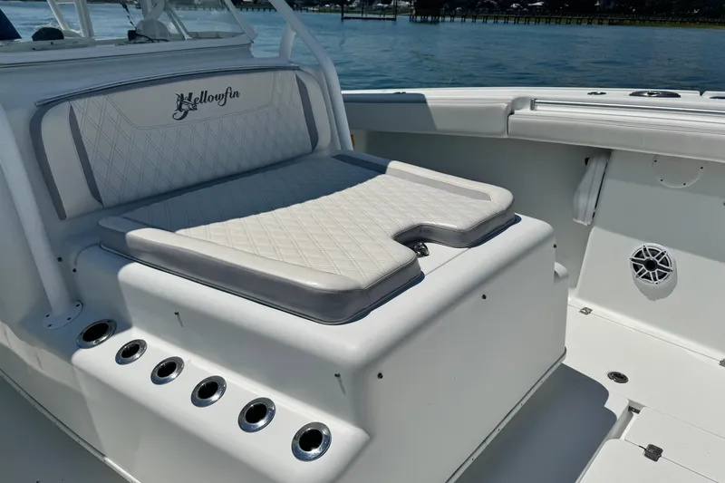 Slide: The Image of 2014 Yellowfin 42 Offshore boat interior with cushioned seating and rod holders. - 21