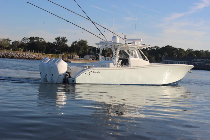 Slide: The Image of 2014 Yellowfin 42 boat on calm water, equipped with multiple outboard engines. - 4