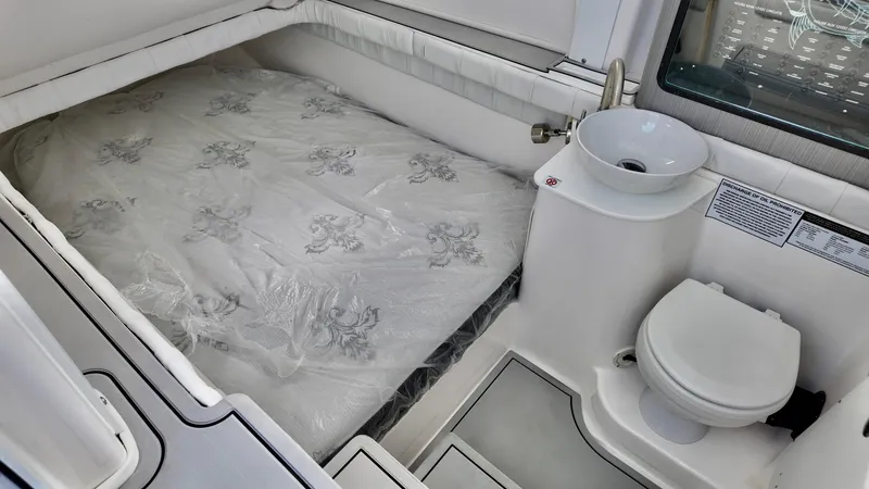 Slide: The Image of 2025 Sea Fox 368 Commander cabin with bed, sink, and toilet. - 16