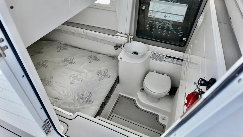 Slide: The Image of 2025 Sea Fox 368 Commander cabin with bed and compact bathroom amenities. - 18