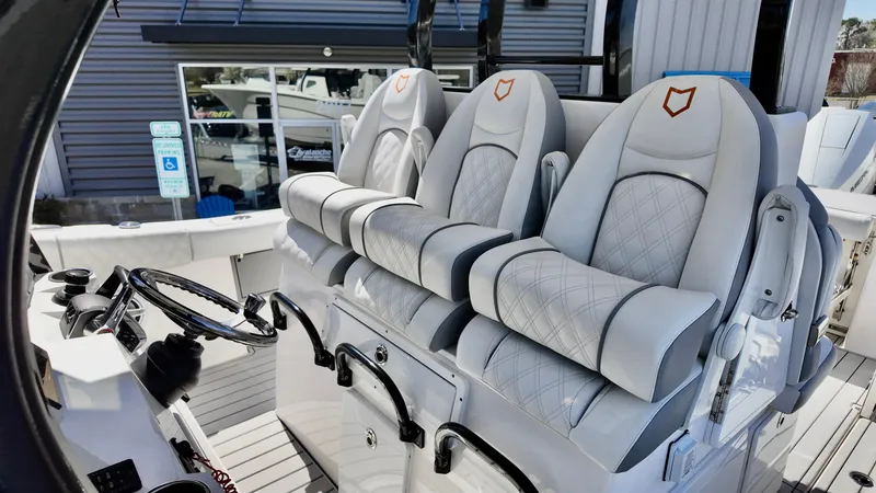 Slide: The Image of 2025 Sea Fox 368 Commander boat interior with luxurious seating and modern steering console. - 19