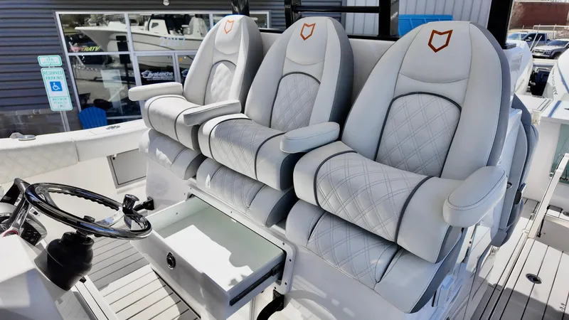 Slide: The Image of Luxurious seating on 2025 Sea Fox 368 Commander boat with elegant design and steering wheel. - 21