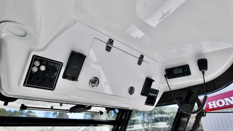 Slide: The Image of 2025 Sea Fox 368 Commander boat console with electronic controls and storage compartments. - 22
