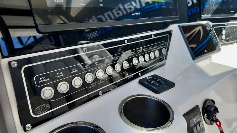 Slide: The Image of Control panel of 2025 Sea Fox 368 Commander boat with buttons and cup holders. - 24
