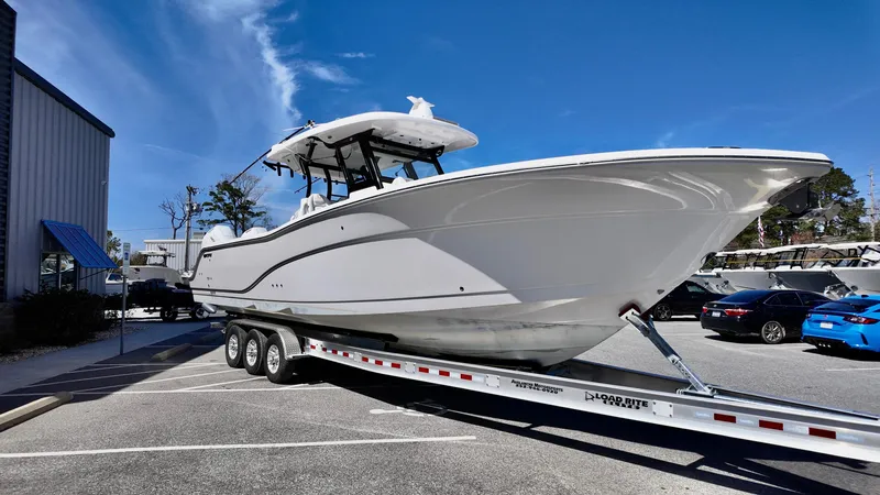 Slide: The Image of 2025 Sea Fox 368 Commander boat on a trailer under a clear blue sky. - 3