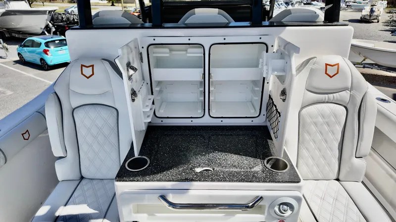 Slide: The Image of 2025 Sea Fox 368 Commander interior with open storage compartments and cushioned seating. - 35