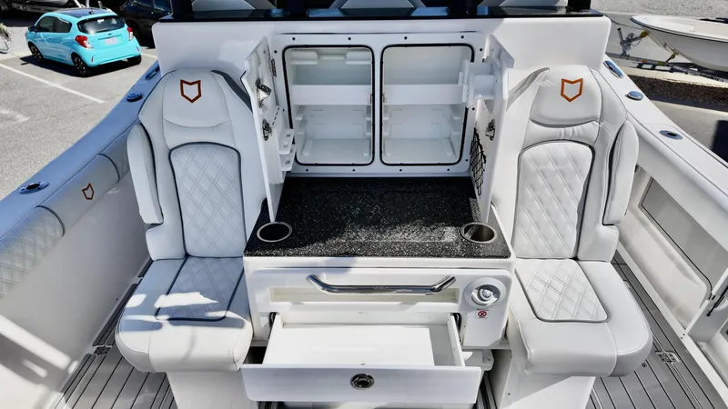 Slide: The Image of 2025 Sea Fox 368 Commander interior with white seating and storage compartments. - 36
