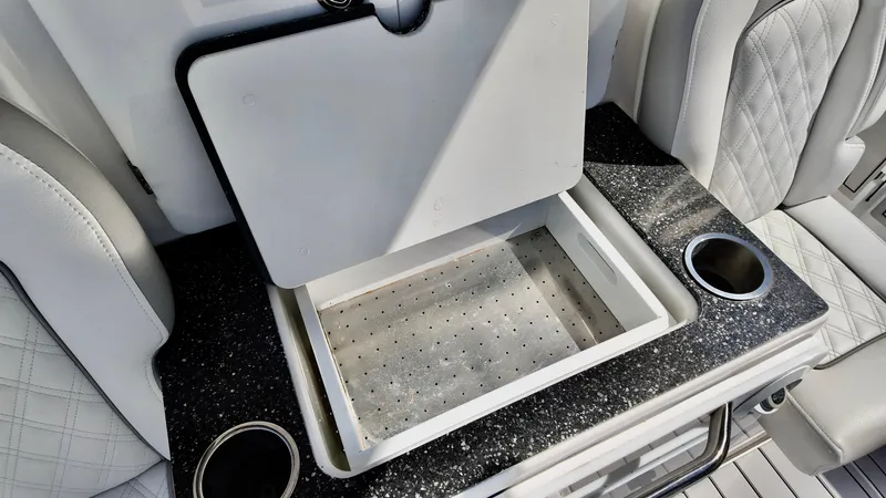 Slide: The Image of 2025 Sea Fox 368 Commander boat interior with storage compartment and cup holders. - 37