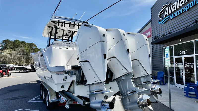 Slide: The Image of 2025 Sea Fox 368 Commander boat with triple outboard engines at dealership. - 4