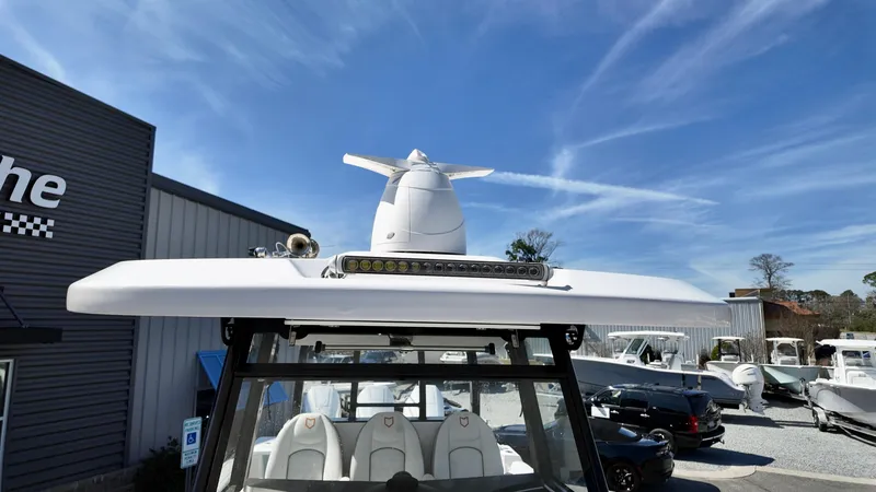 Slide: The Image of 2025 Sea Fox 368 Commander boat with radar, docked under clear blue sky. - 43