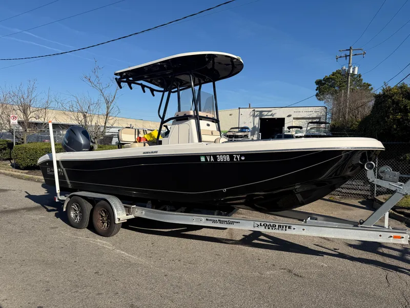 Slide: The Image of 2021 Carolina Skiff 23 Ultra Elite boat on trailer, parked outdoors. - 0