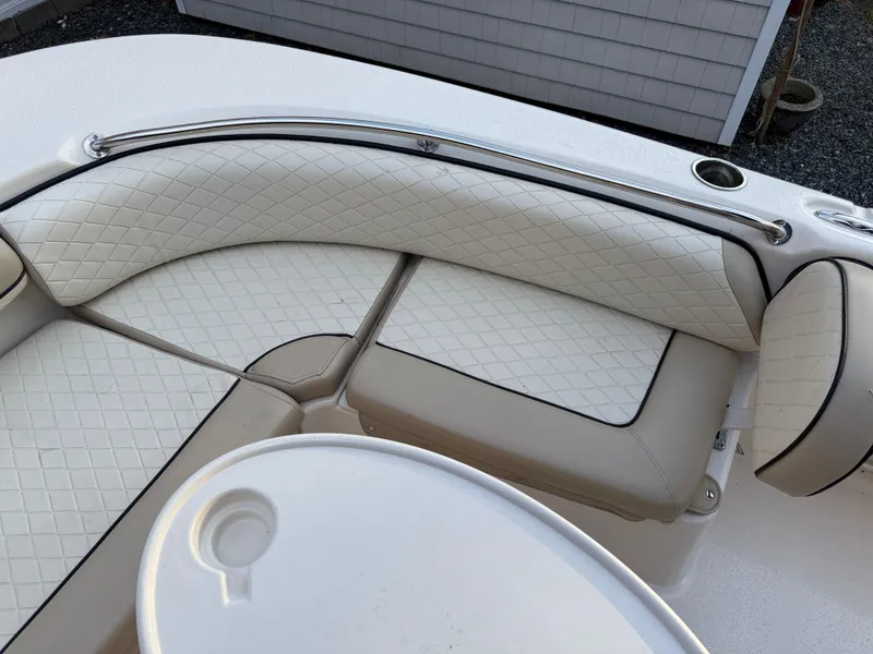 Slide: The Image of 2021 Carolina Skiff 23 Ultra Elite boat interior with cushioned seating and sleek design. - 14