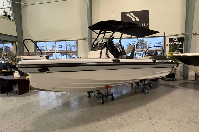 Slide: The Image of 2026 Highfield ADV7 boat displayed indoors on stands. - 0