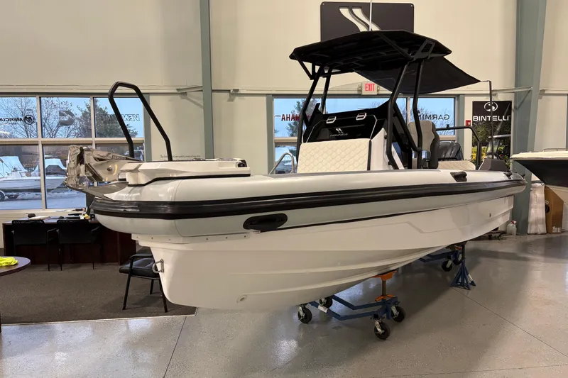 Slide: The Image of 2026 Highfield ADV7 boat displayed indoors, featuring sleek design and modern features. - 1