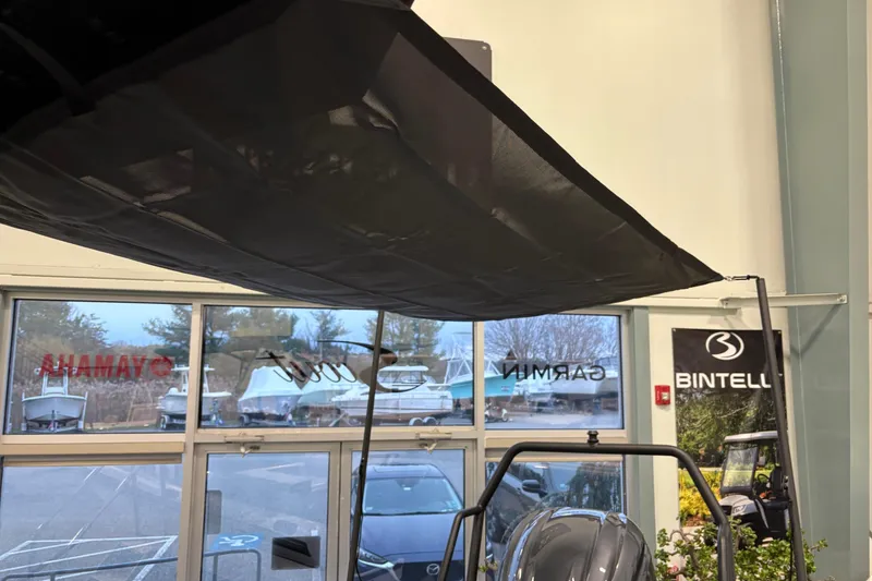 Slide: The Image of 2026 Highfield ADV7 boat displayed indoors with visible canopy and showroom banners. - 10