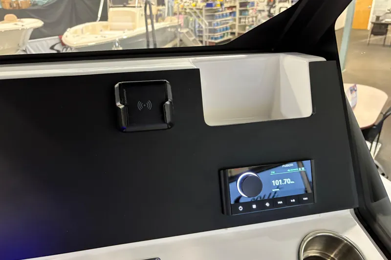 Slide: The Image of Control panel of 2026 Highfield ADV7 boat with radio display and cup holder. - 15