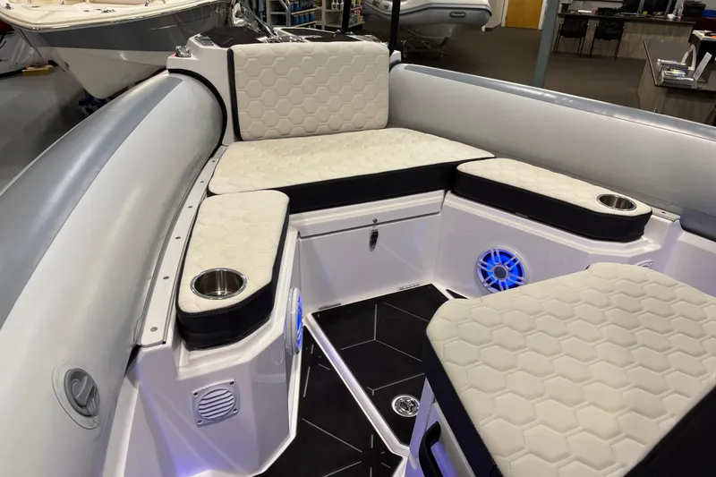 Slide: The Image of 2026 Highfield ADV7 boat interior with hexagonal-patterned seating and cup holders. - 19