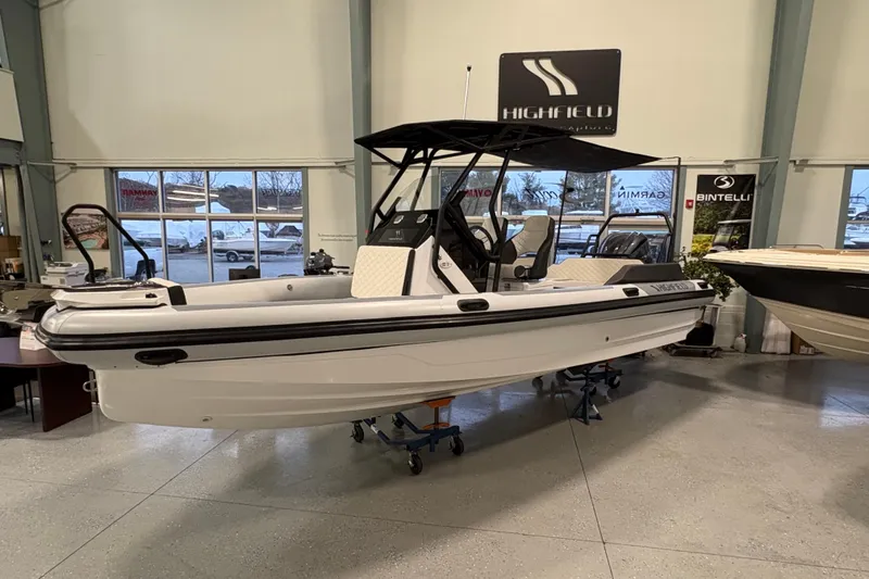 Slide: The Image of 2026 Highfield ADV7 boat displayed indoors, featuring sleek design and modern seating. - 2