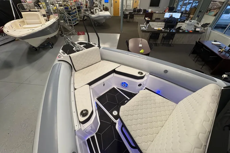 Slide: The Image of 2026 Highfield ADV7 boat interior with cushioned seating and modern design in showroom. - 20