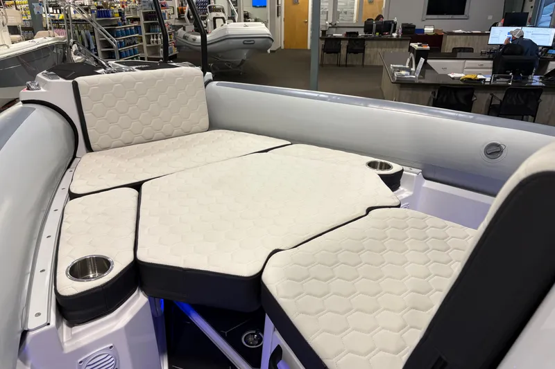 Slide: The Image of 2026 Highfield ADV7 boat interior with hexagonal-patterned seating and cup holders. - 22