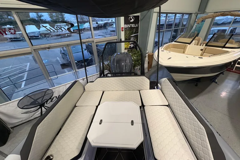 Slide: The Image of 2026 Highfield ADV7 boat interior with cushioned seating in showroom. - 6
