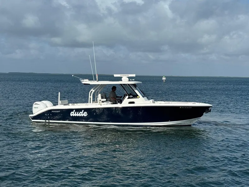 Slide: The Image of 2022 Pursuit S 328 Sport boat cruising on open water under cloudy skies. - 1