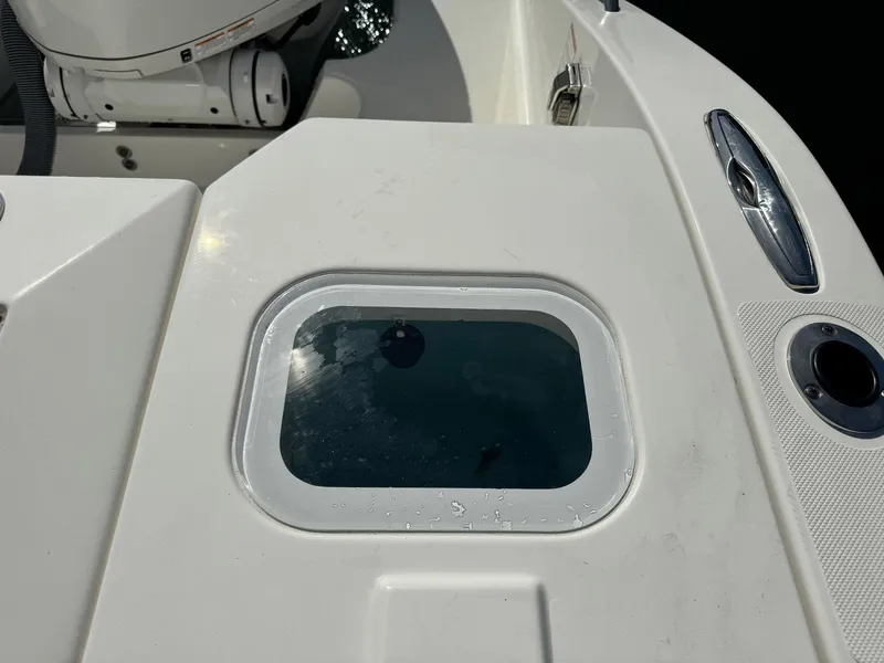 Slide: The Image of 2022 Pursuit S 328 Sport boat deck with livewell and motor detail. - 10