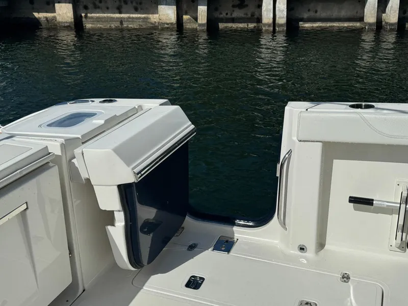 Slide: The Image of 2022 Pursuit S 328 Sport boat deck near water, showcasing sleek design and functionality. - 16