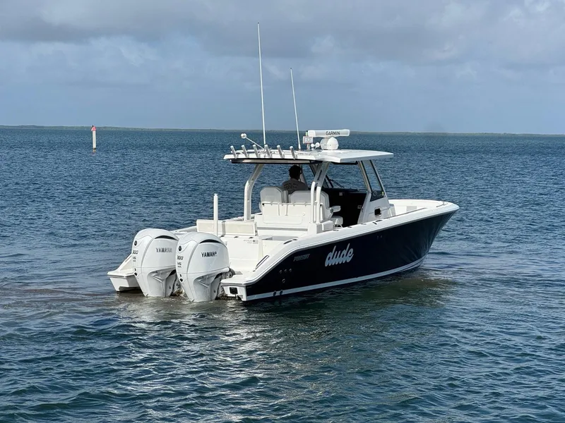 Slide: The Image of 2022 Pursuit S 328 Sport boat on open water with twin Yamaha engines. - 3