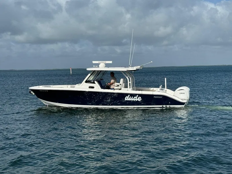 Slide: The Image of 2022 Pursuit S 328 Sport boat cruising on open water under cloudy skies. - 4