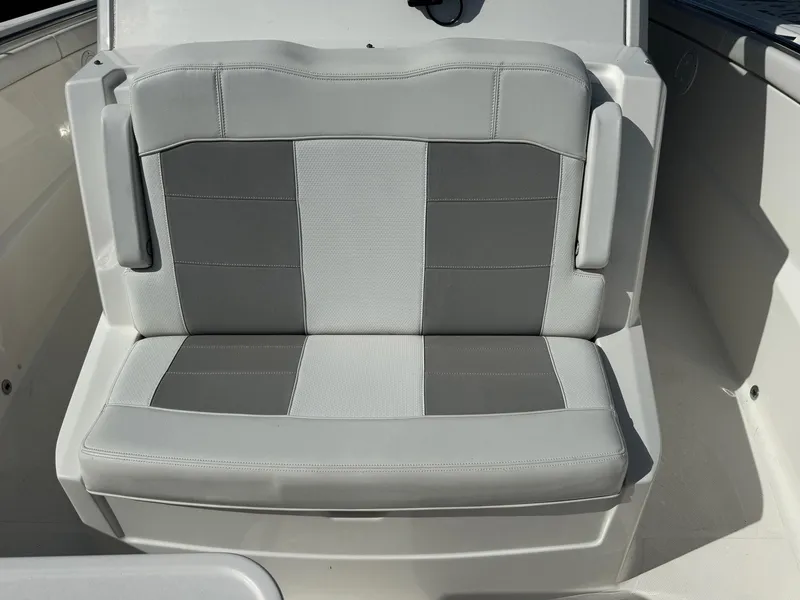 Slide: The Image of 2022 Pursuit S 328 Sport boat seat with gray and white upholstery. - 6