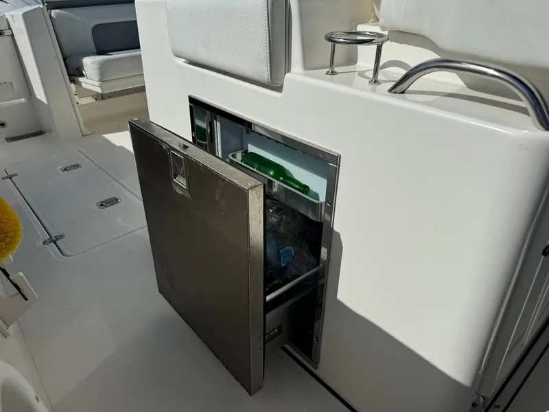 Slide: The Image of 2022 Pursuit S 328 Sport boat with open built-in storage compartment. - 9