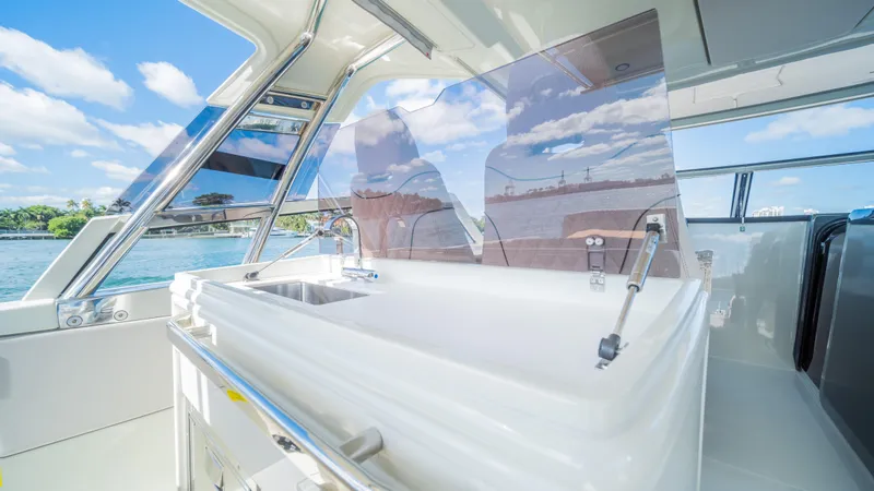 Slide: The Image of Luxurious YOT 36 yacht interior with modern sink, panoramic windows, and ocean view, 2025 model. - 24