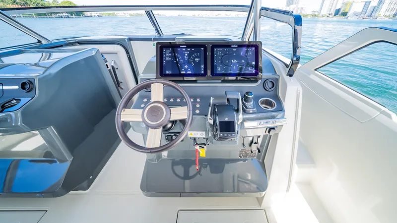 Slide: The Image of Helm of 2025 YOT 36 boat with dual screens and modern controls. - 25