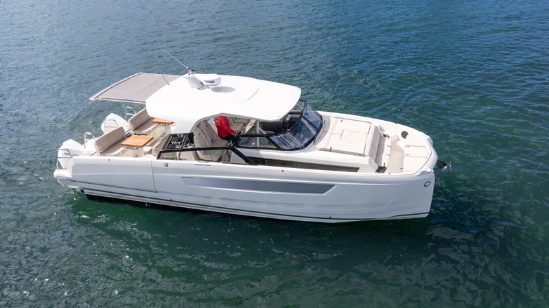 Slide: The Image of 2025 YOT 36 boat on calm water, featuring sleek design and spacious deck. - 4