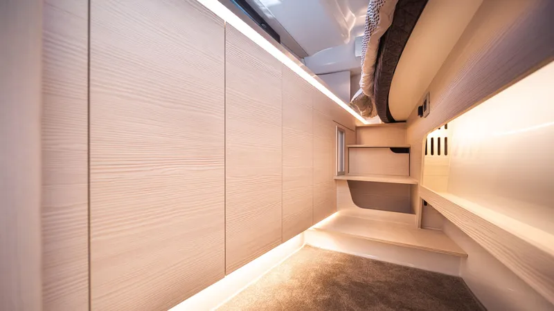 Slide: The Image of Modern interior of 2025 YOT 36 yacht with sleek wood paneling and ambient lighting. - 43