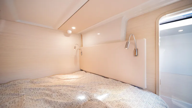 Slide: The Image of Cozy bedroom interior of 2025 YOT 36 yacht with modern lighting and elegant design. - 44