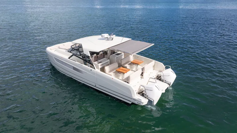 Slide: The Image of Modern 2025 YOT 36 boat on calm blue water, featuring spacious seating and sleek design. - 7