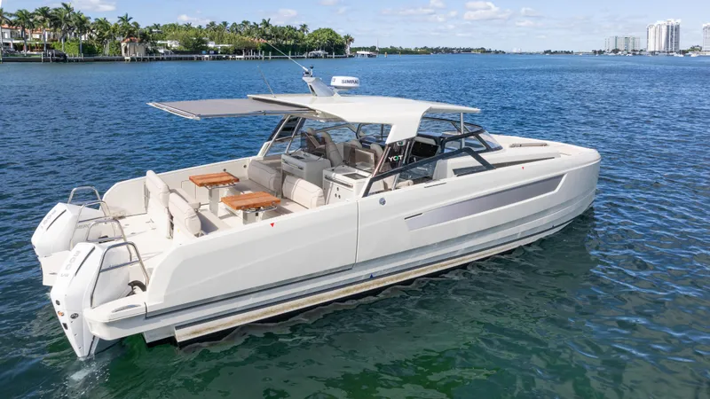 Slide: The Image of Luxury 2025 YOT 36 motor yacht cruising on a sunny, tropical waterway. - 9
